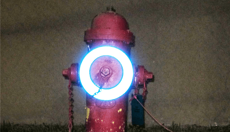 Red fire hydrant with glowing blue ring.