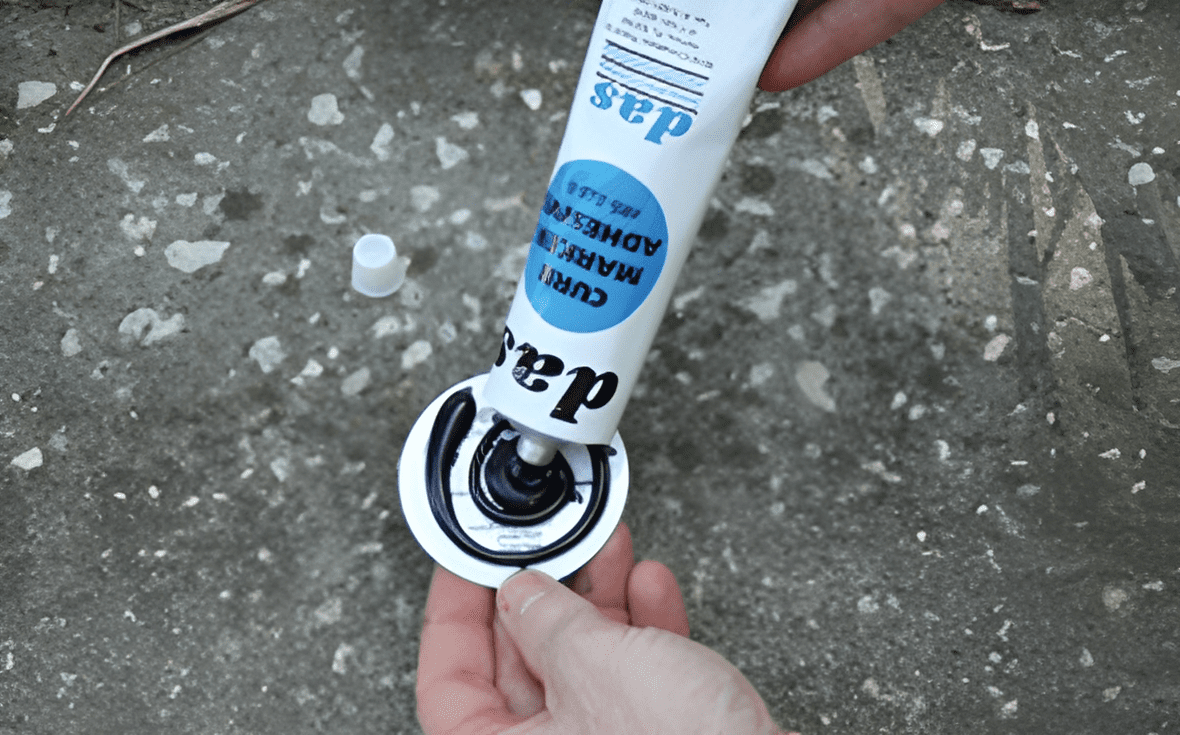 Applying adhesive to a circular object.